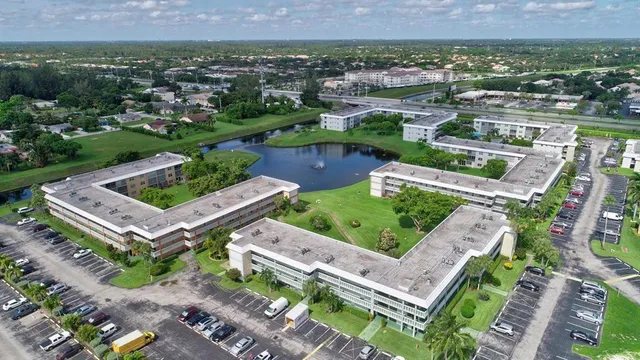 an aerial view of a house with a garden and lake view