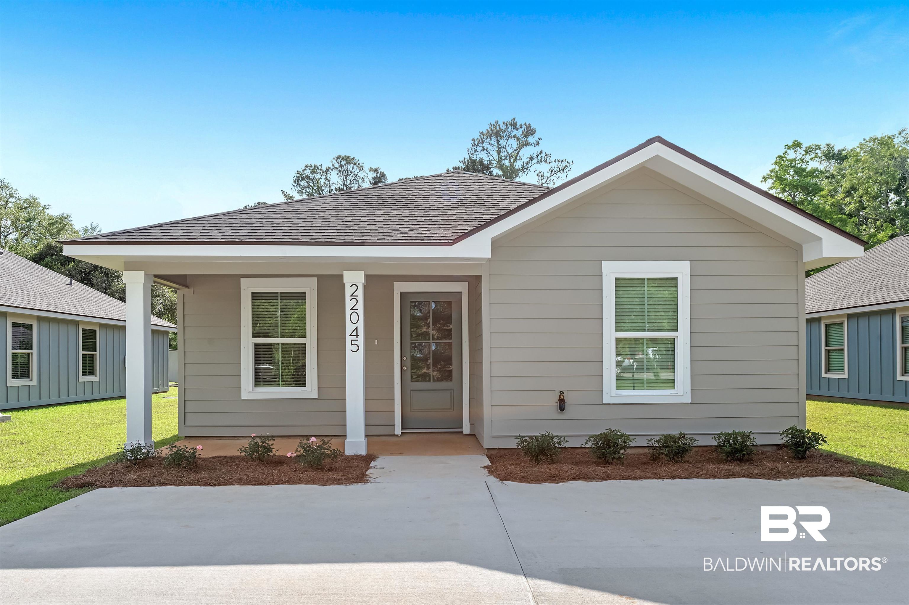 22045 8th Street Silverhill, AL 36576 - Photo 1 of 39 Bungalow with a front lawn, covered porch, and roof with shingles