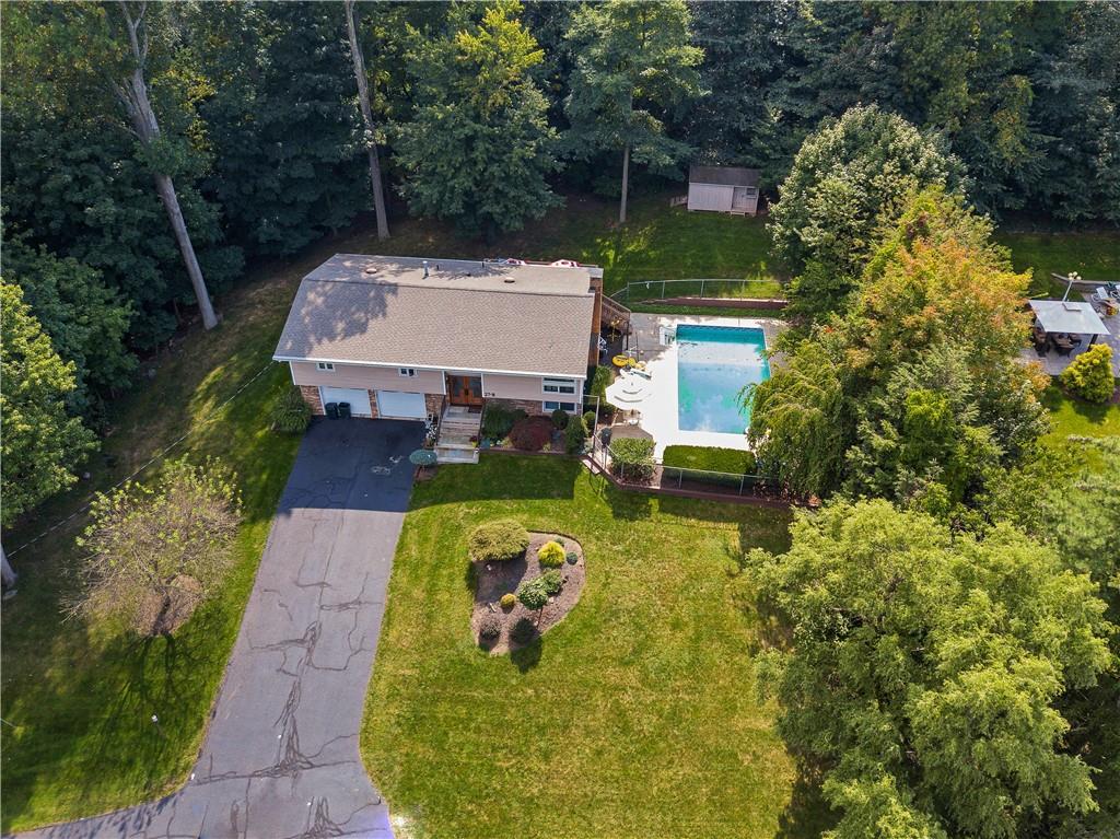 an aerial view of a house with swimming pool and garden