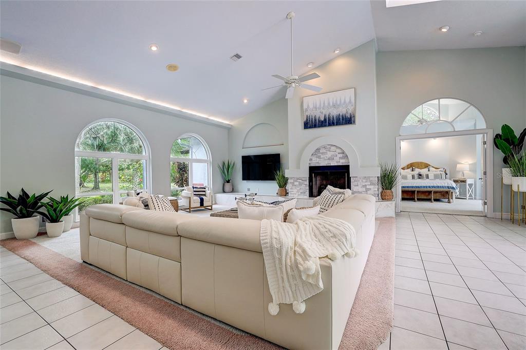 181 South Auburn Road Venice, FL 34292 - Photo 11 of 91 a living room with furniture fireplace and a large window