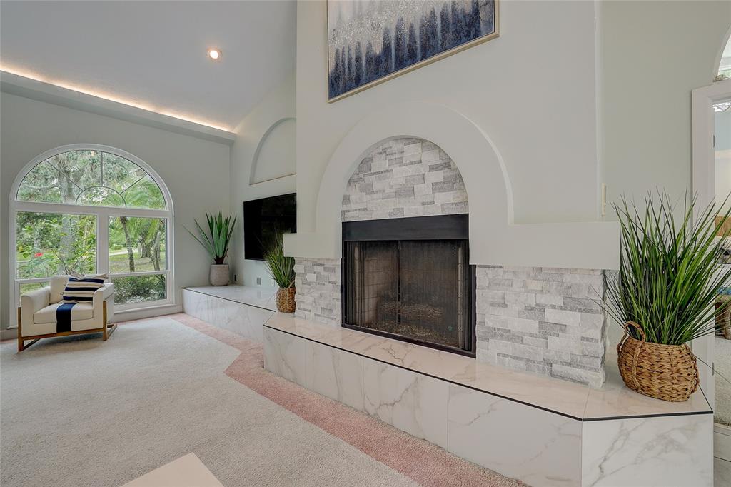 181 South Auburn Road Venice, FL 34292 - Photo 15 of 91 a living room with furniture and a fireplace