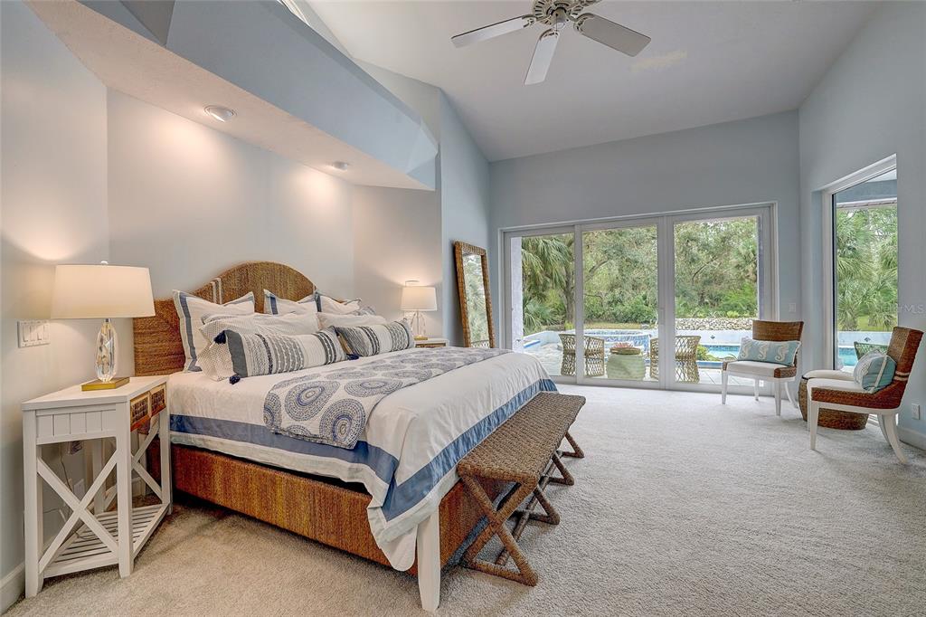 181 South Auburn Road Venice, FL 34292 - Photo 28 of 91 a bed room with a bed and a chandelier