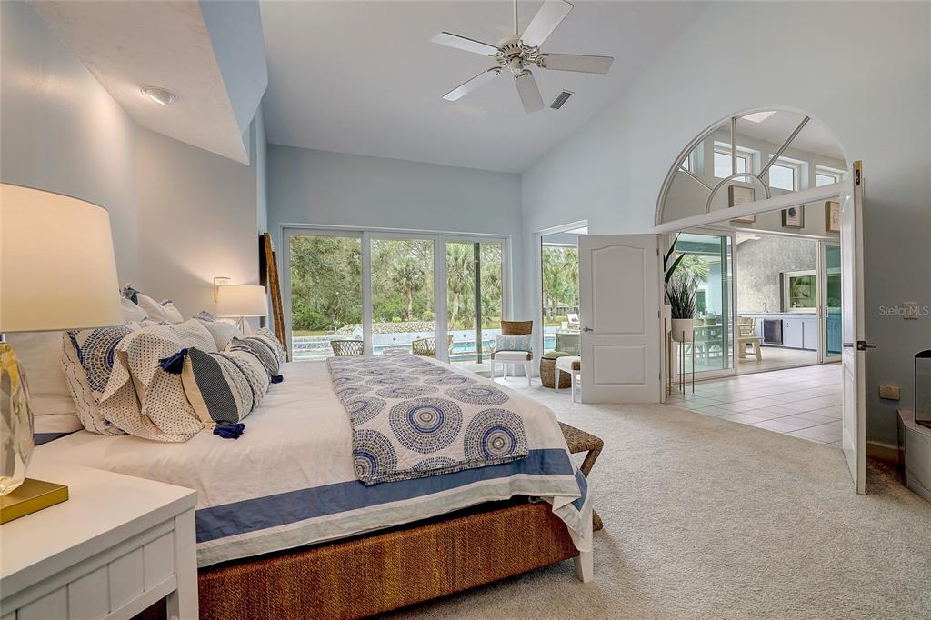 181 South Auburn Road Venice, FL 34292 - Photo 29 of 91 a bedroom with furniture and a large window