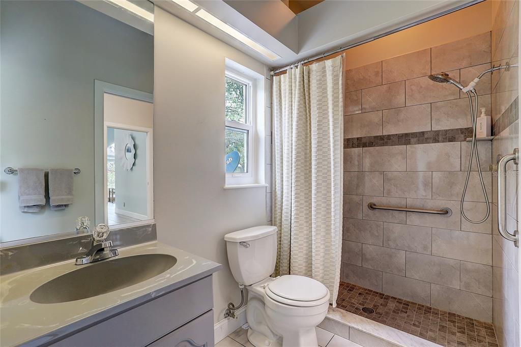 181 South Auburn Road Venice, FL 34292 - Photo 41 of 91 a bathroom with a sink toilet a mirror and shower