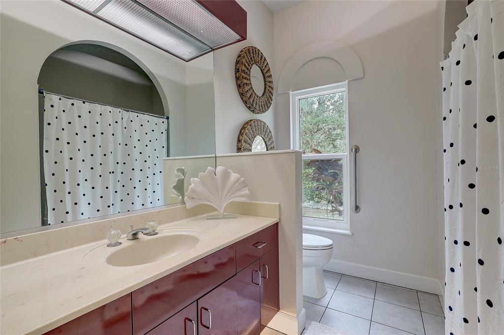 181 South Auburn Road Venice, FL 34292 - Photo 42 of 91 a bathroom with a sink a toilet and a mirror