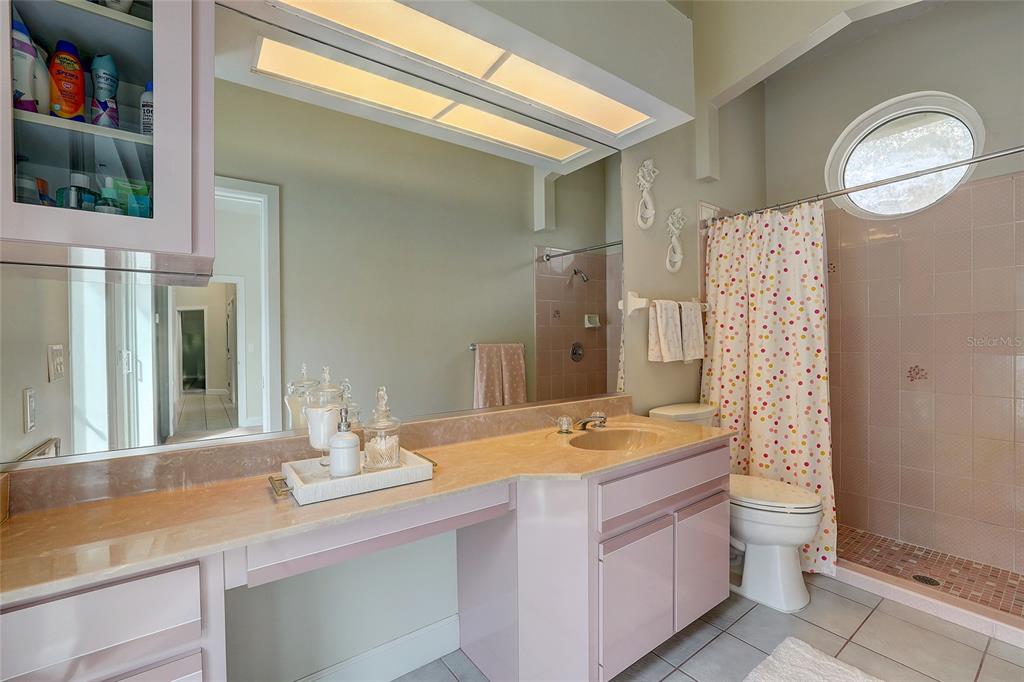 181 South Auburn Road Venice, FL 34292 - Photo 46 of 91 a bathroom with a granite countertop sink a toilet a mirror and shower