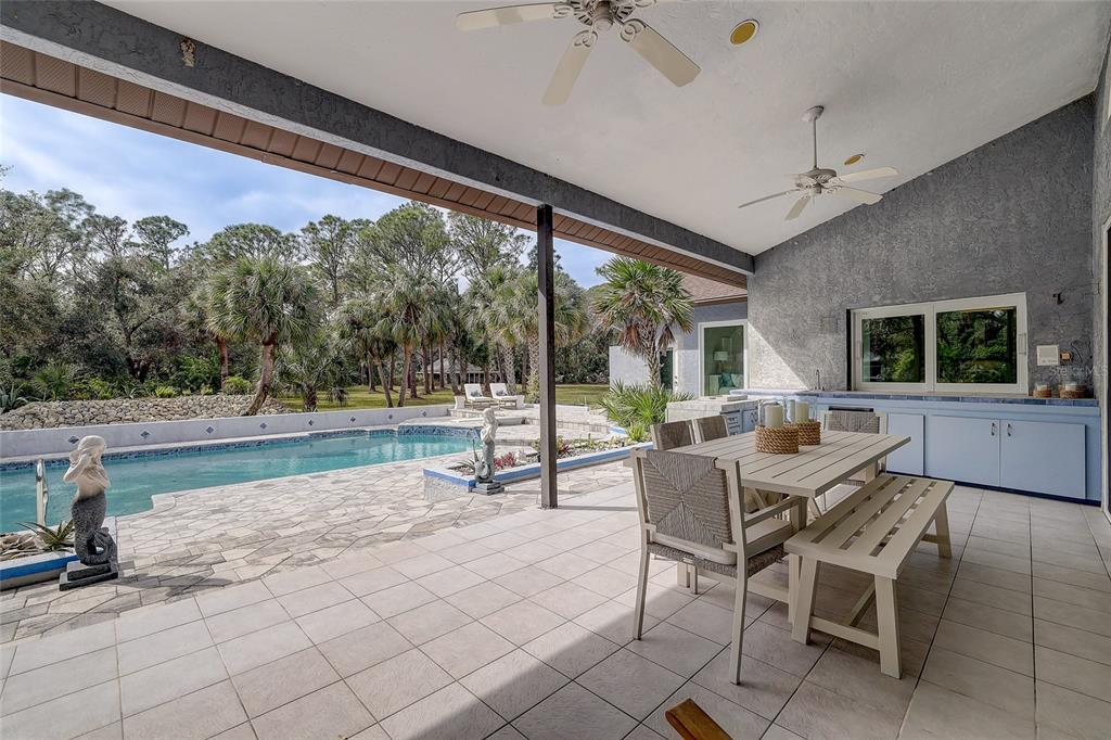 181 South Auburn Road Venice, FL 34292 - Photo 53 of 91 a patio with a table and chairs
