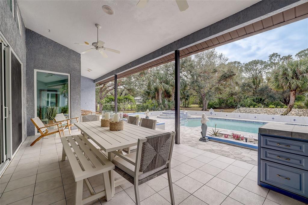 181 South Auburn Road Venice, FL 34292 - Photo 55 of 91 a dining room with furniture a chandelier and a rug