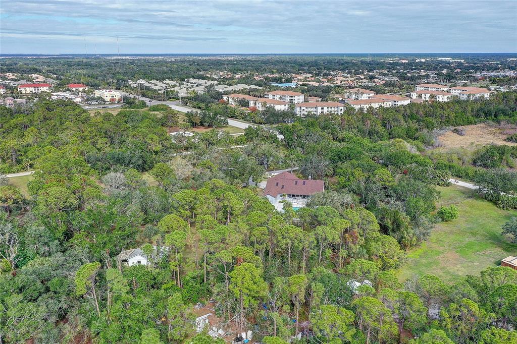 181 South Auburn Road Venice, FL 34292 - Photo 70 of 91 an aerial view of residential house with outdoor space and trees all around