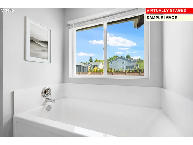 a bathroom with a bathtub and a window
