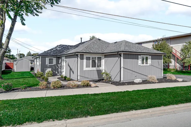 a view of a house with backyard sitting area and garden