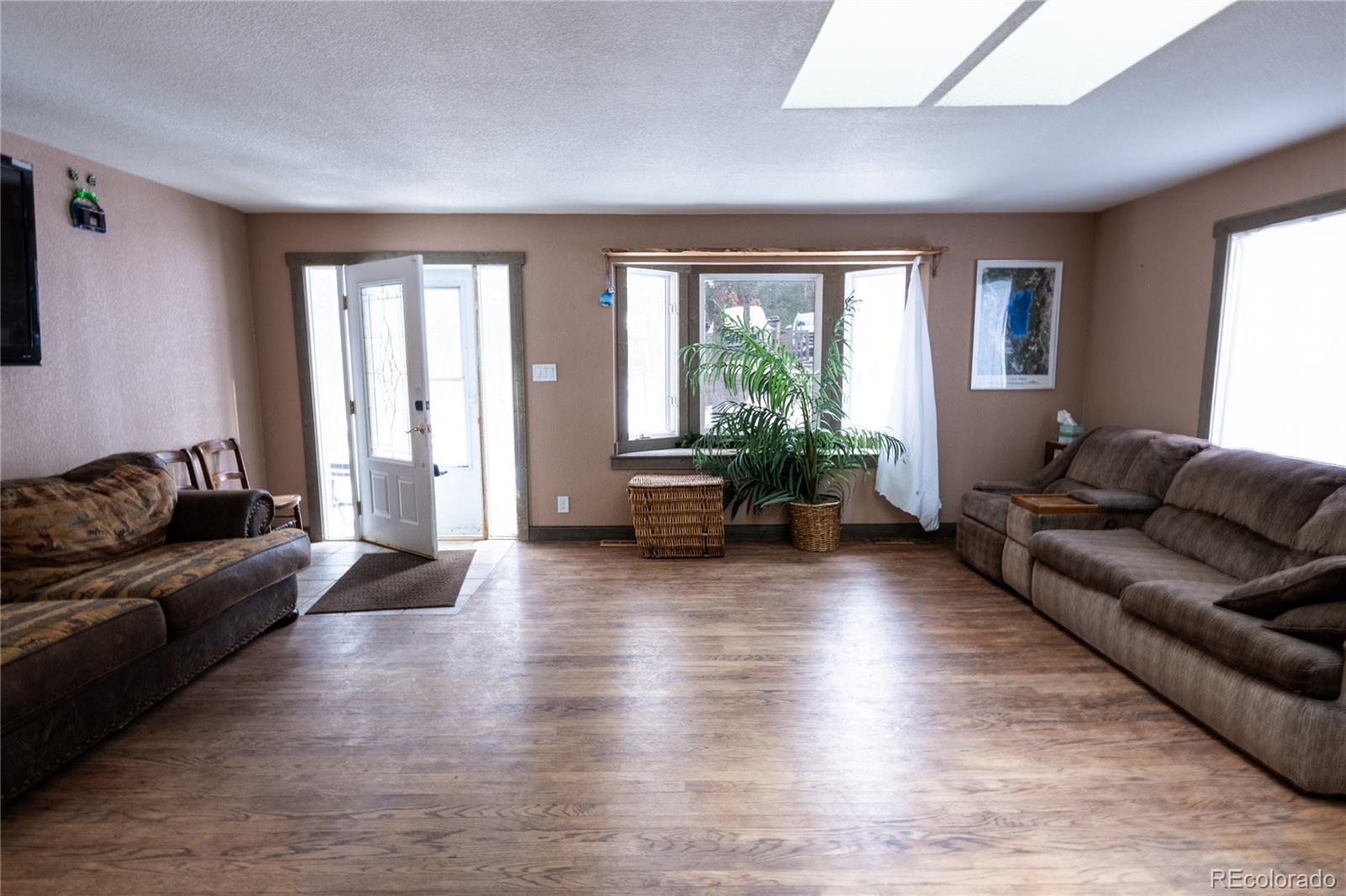 983 Wagon Trail Road Evergreen, CO 80439 - Photo 15 of 47 a living room with furniture and a large window