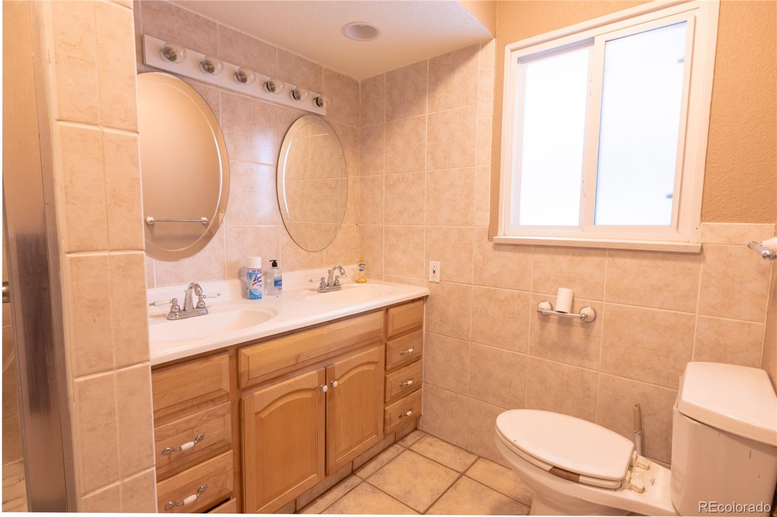 983 Wagon Trail Road Evergreen, CO 80439 - Photo 26 of 47 a bathroom with a granite countertop toilet sink and mirror