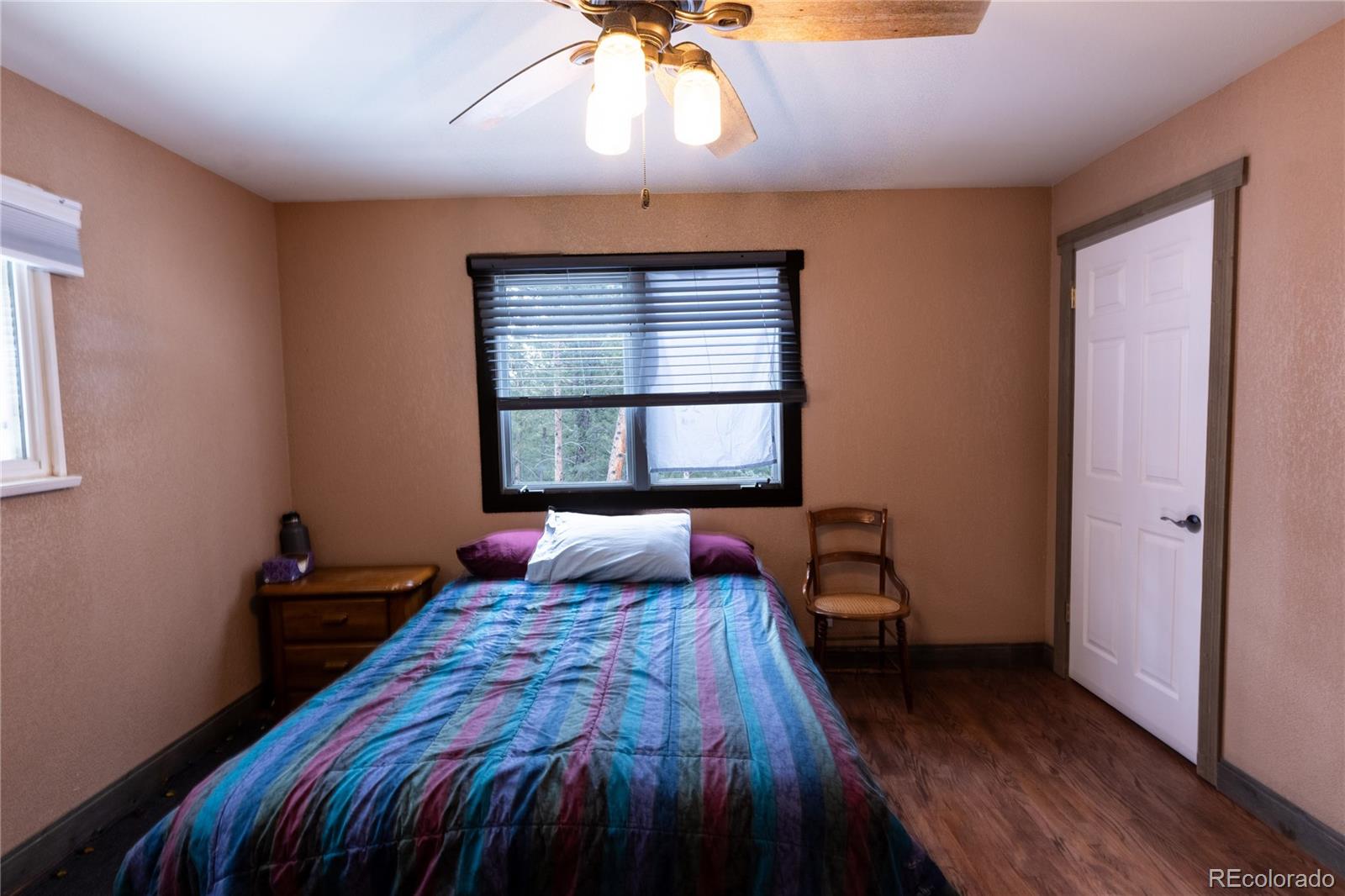 983 Wagon Trail Road Evergreen, CO 80439 - Photo 28 of 47 a bedroom with a bed and a window