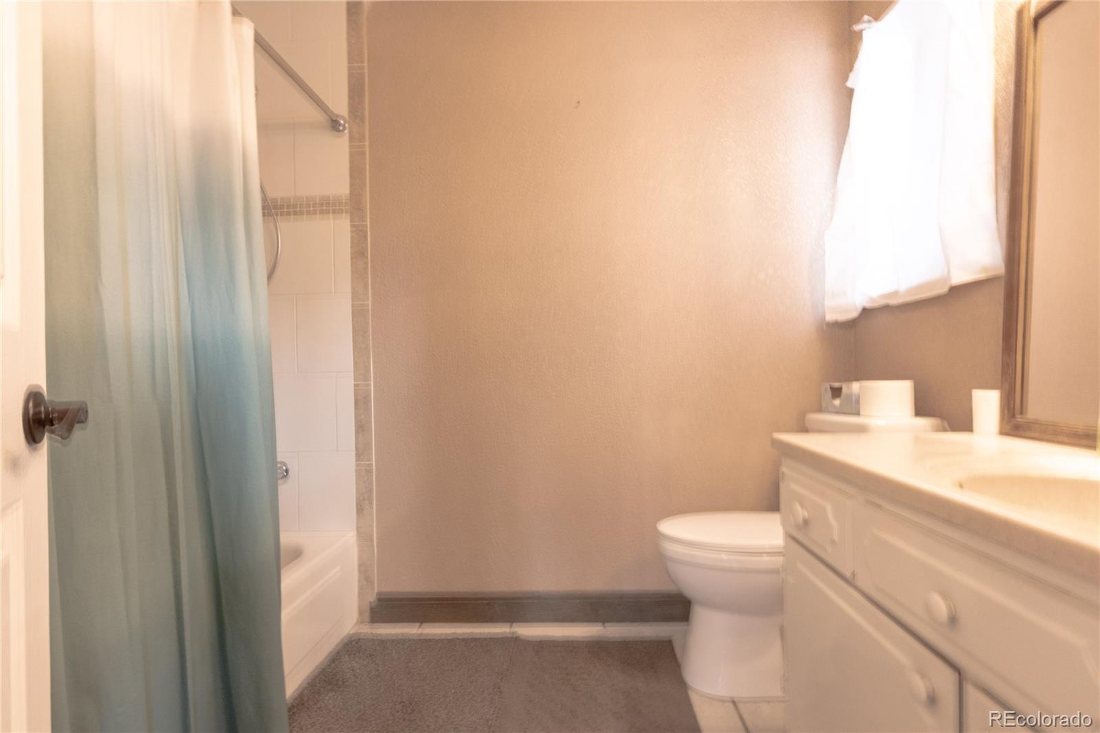 983 Wagon Trail Road Evergreen, CO 80439 - Photo 29 of 47 a bathroom with a sink a toilet and a mirror