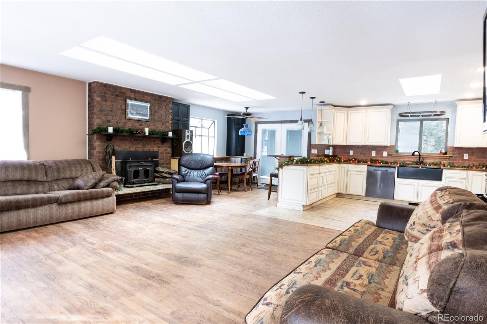 983 Wagon Trail Road Evergreen, CO 80439 - Photo 3 of 47 a living room with furniture and a flat screen tv