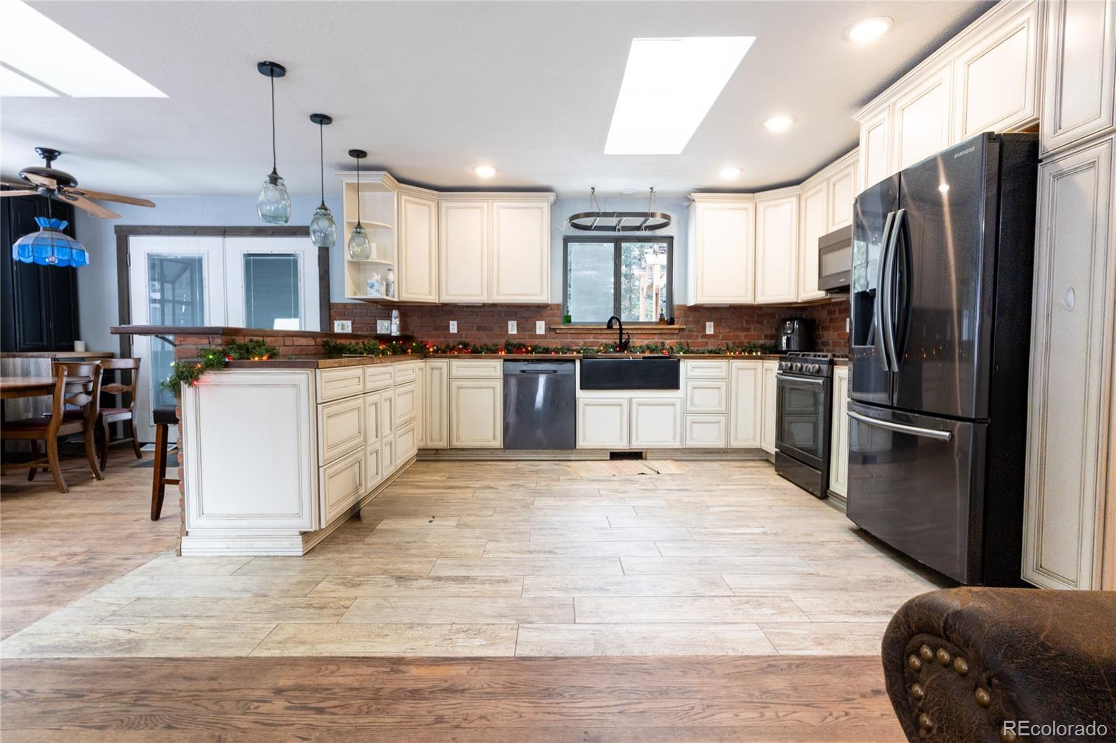 983 Wagon Trail Road Evergreen, CO 80439 - Photo 6 of 47 a large kitchen with stainless steel appliances granite countertop a stove refrigerator and a sink