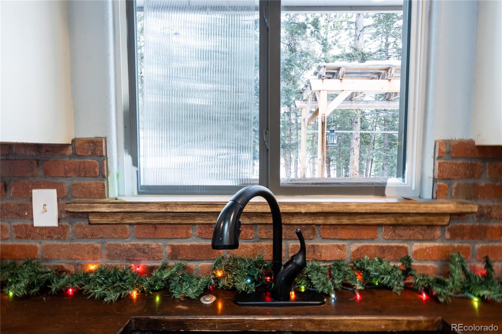 983 Wagon Trail Road Evergreen, CO 80439 - Photo 8 of 47 a front view of a house with a yard