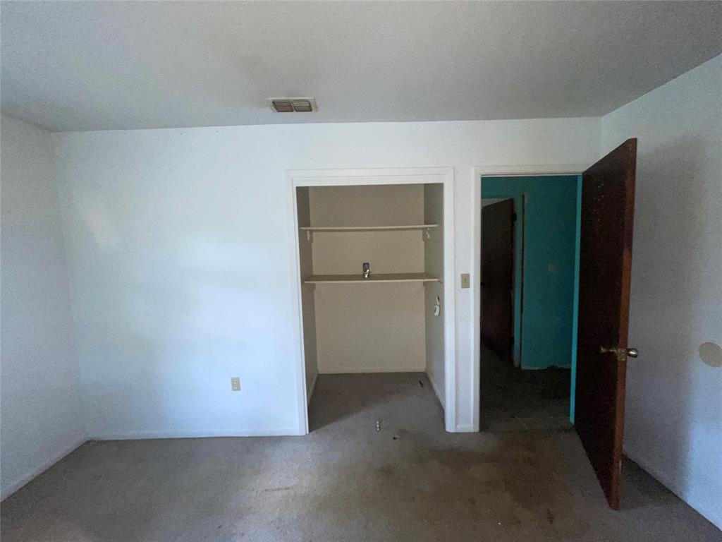 188 Pryor Street Rusk, TX 75785 - Photo 17 of 22 an empty room with closet and wooden door