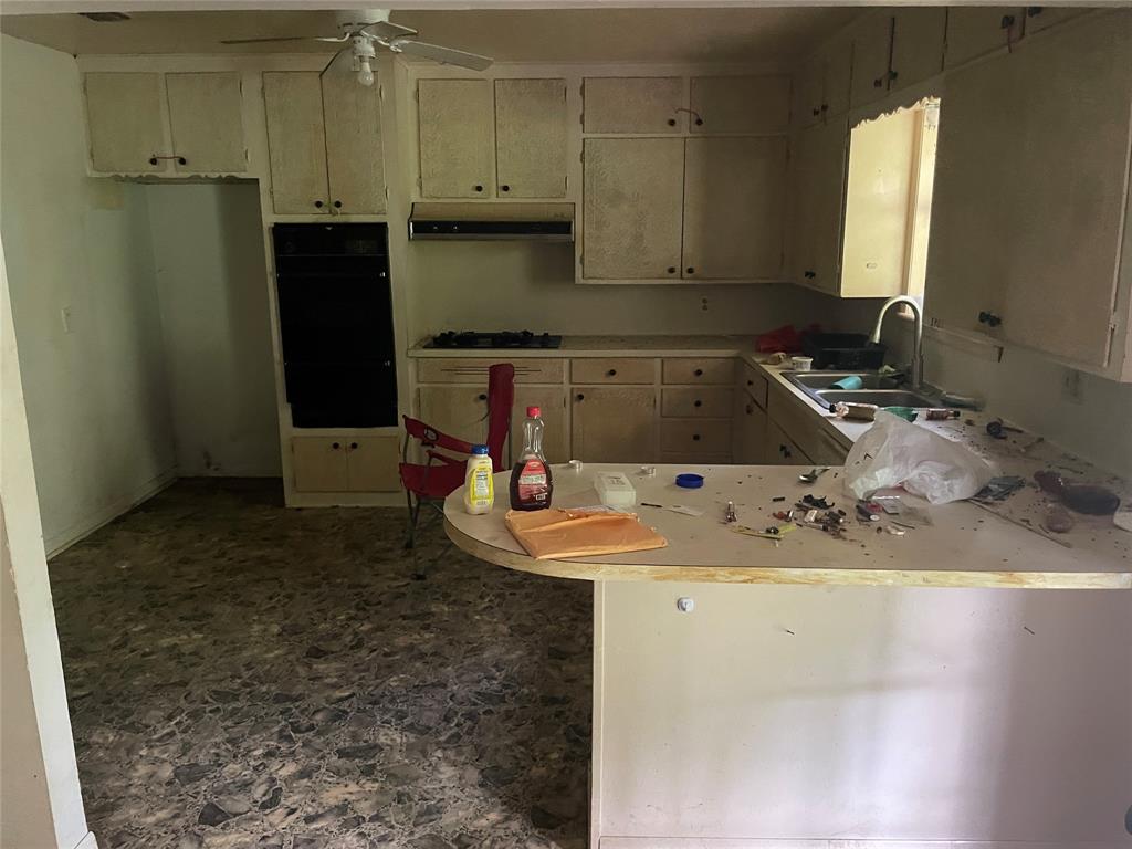 188 Pryor Street Rusk, TX 75785 - Photo 8 of 22 a kitchen with a sink a refrigerator and cabinets