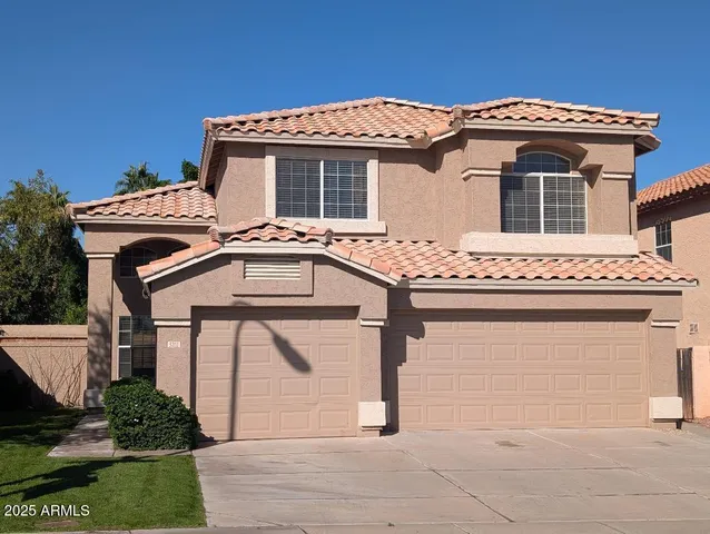 a front view of a house with a garage