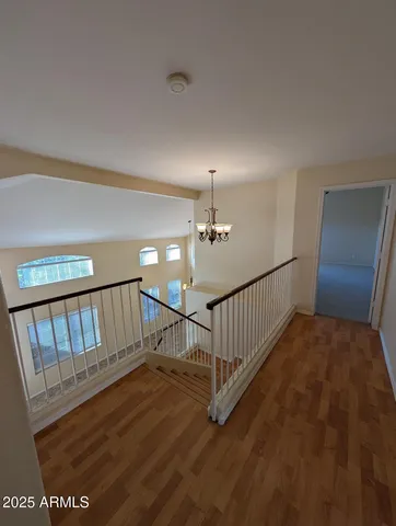 a view of staircase with railing and white walls