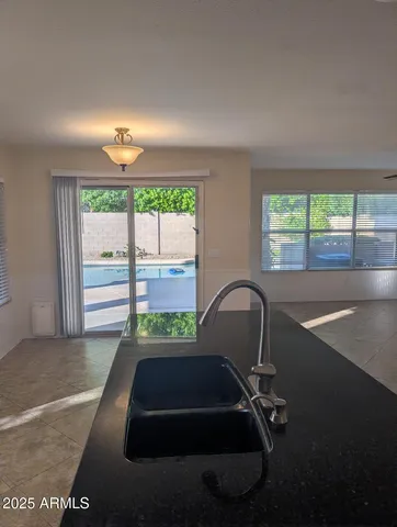 a room with pool table and large windows