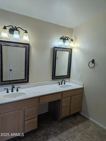 a bathroom with a double vanity sink and mirror
