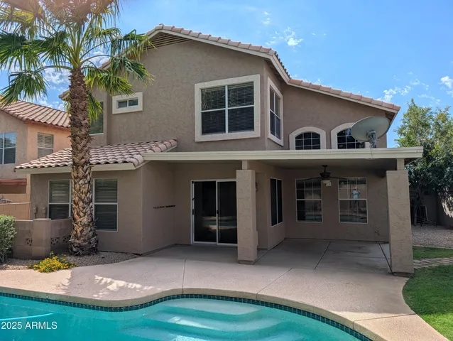 a view of a house with a yard and sitting area