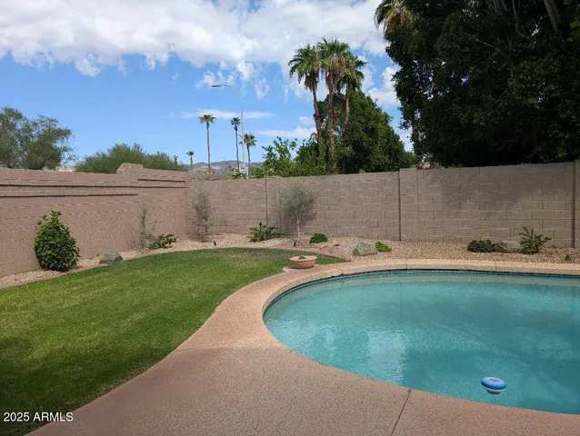 a view of a swimming pool and a yard