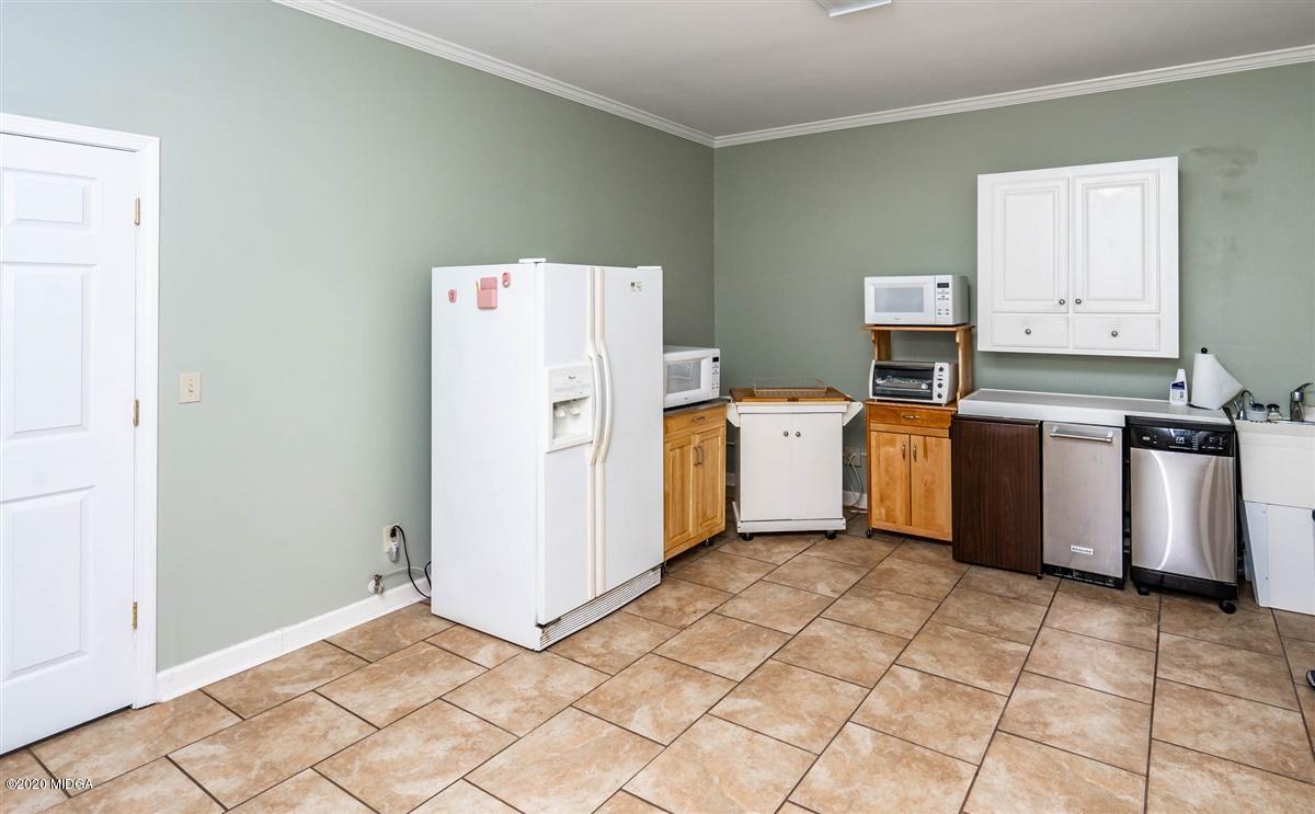1934 Reedy Creek Road Forsyth, GA 31029 - Photo 22 of 51 a utility room with cabinets washer and dryer