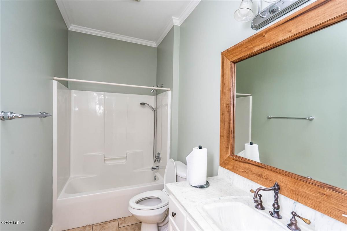 1934 Reedy Creek Road Forsyth, GA 31029 - Photo 24 of 51 a bathroom with a bathtub shower sink vanity mirror and toilet