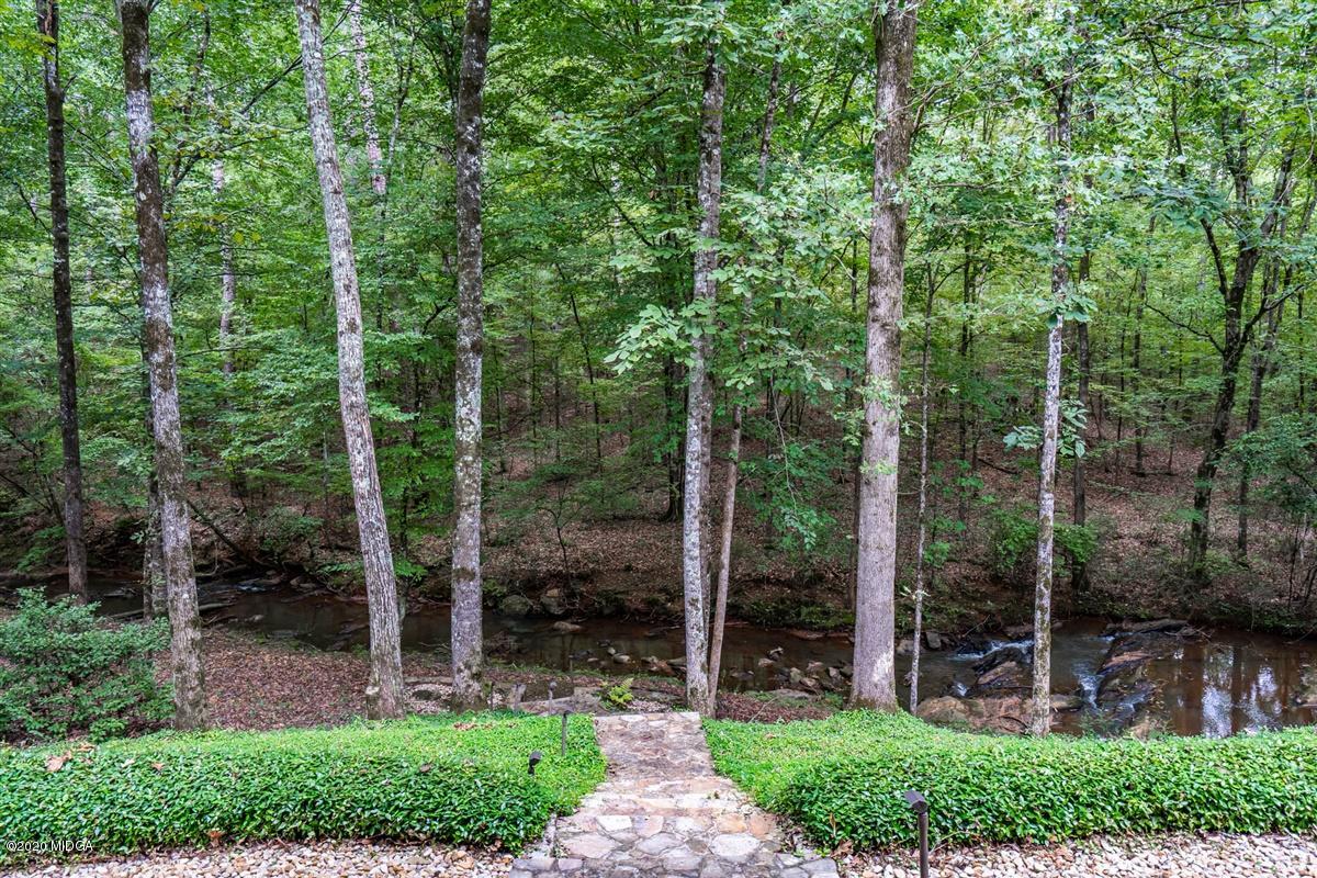 1934 Reedy Creek Road Forsyth, GA 31029 - Photo 31 of 51 a view of a park that has large trees and a wooden fence