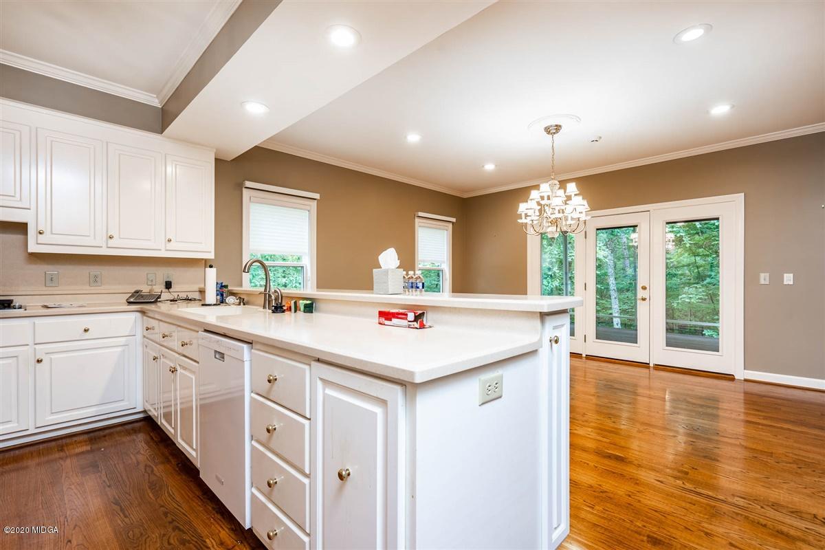 1934 Reedy Creek Road Forsyth, GA 31029 - Photo 34 of 51 a kitchen with kitchen island granite countertop a stove and a large window