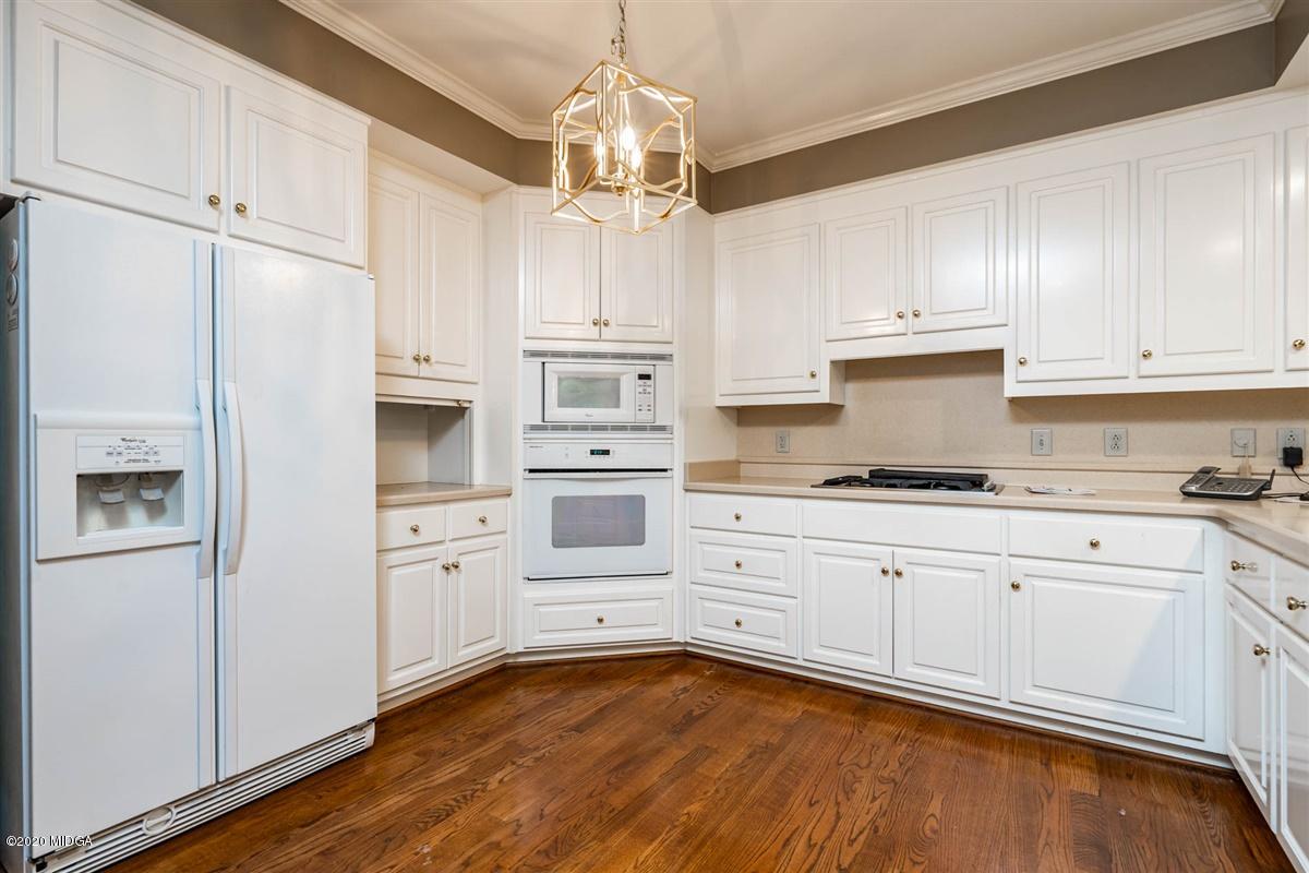 1934 Reedy Creek Road Forsyth, GA 31029 - Photo 35 of 51 a kitchen with white cabinets and white appliances