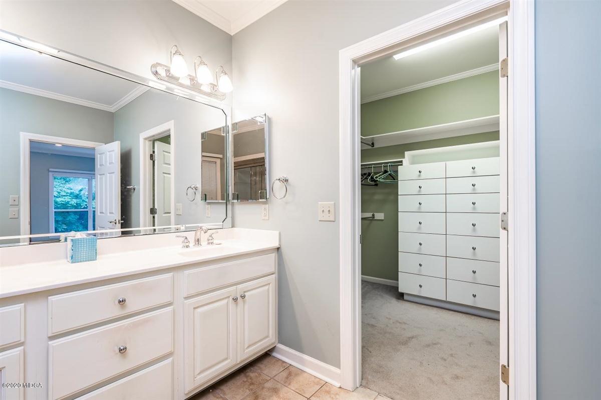 1934 Reedy Creek Road Forsyth, GA 31029 - Photo 46 of 51 a spacious bathroom with a double vanity sink a large mirror a shower and a vanity
