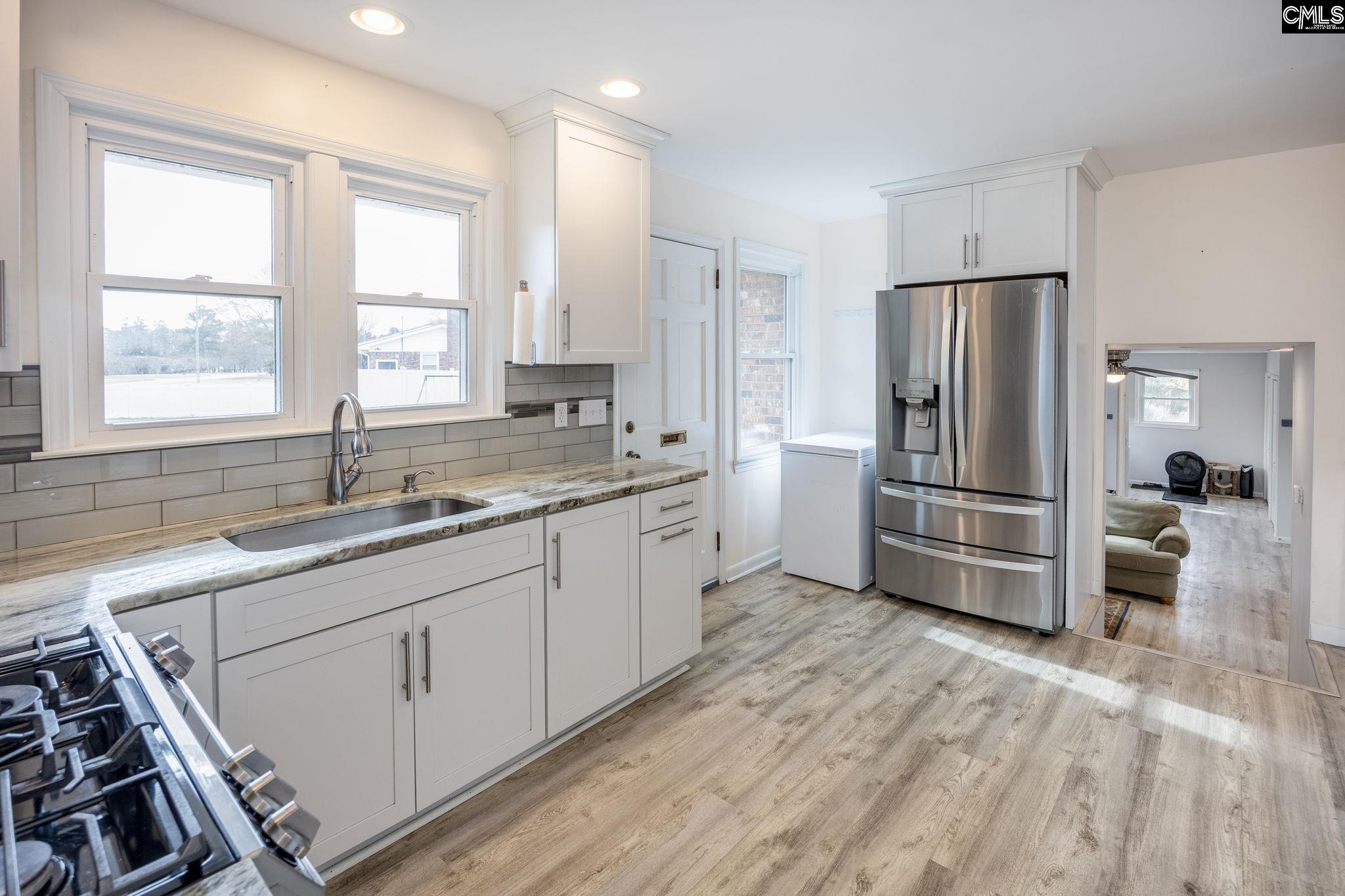 560 Edisto Street Batesburg, SC 29006 - Photo 13 of 49 a kitchen with granite countertop a refrigerator and a sink