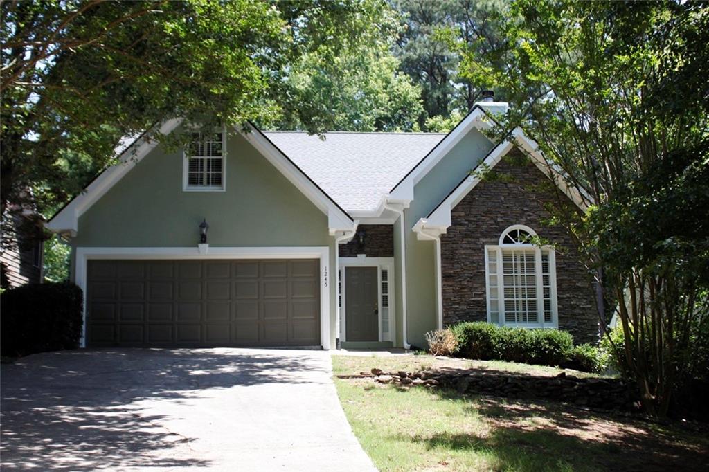 a front view of a house with a yard garage and outdoor seating