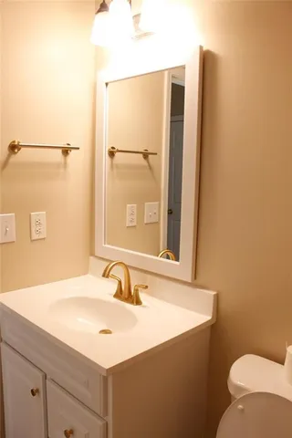a bathroom with a granite countertop shower and a toilet