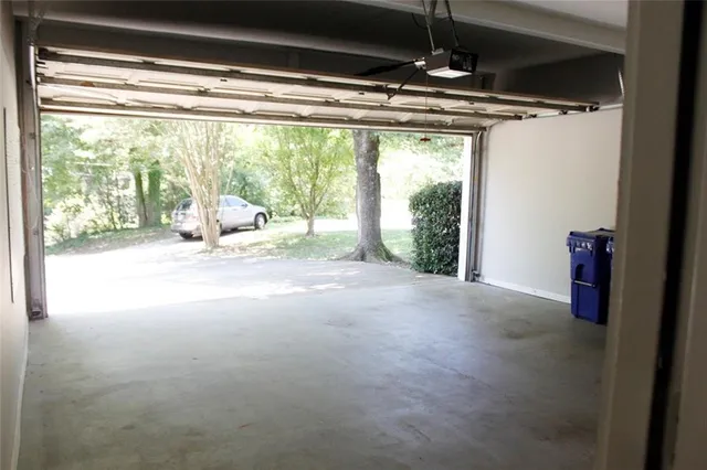 a view of empty room with floor to ceiling window and an outdoor view