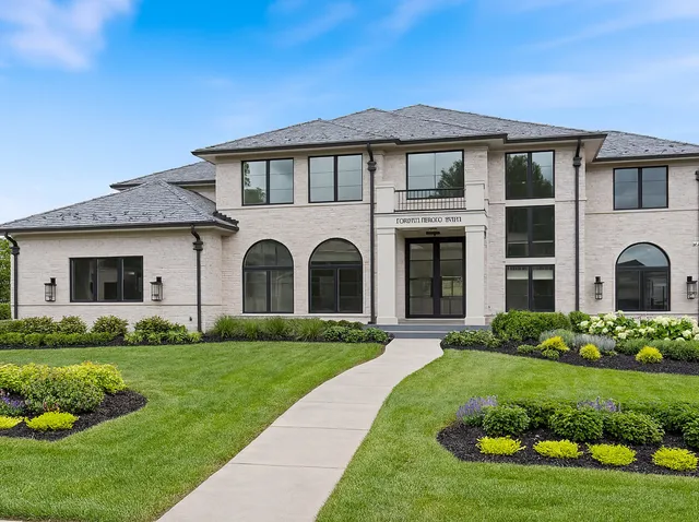 a front view of a house with a garden