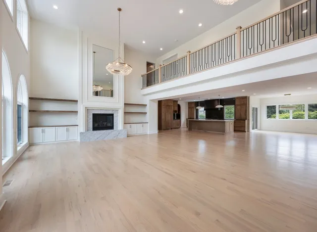 a kitchen with stainless steel appliances granite countertop a stove and a wooden floors