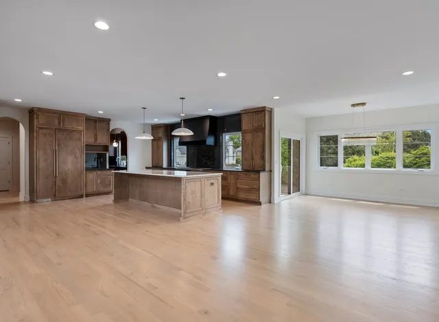 a kitchen with stainless steel appliances granite countertop a sink a stove and a refrigerator