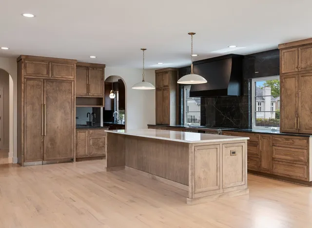 a kitchen with stainless steel appliances granite countertop a stove and a refrigerator
