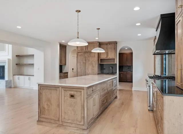 a kitchen with granite countertop a sink stainless steel appliances and cabinets