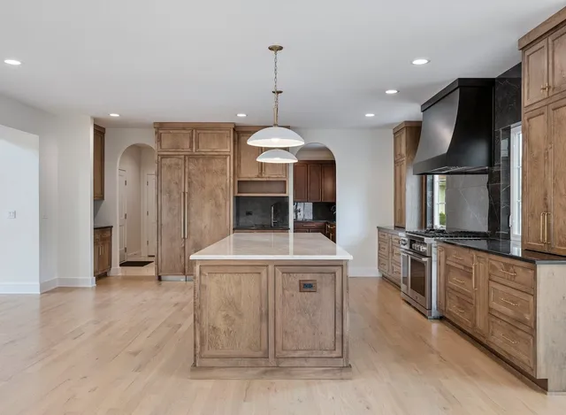 a kitchen with granite countertop wooden cabinets a sink and dishwasher