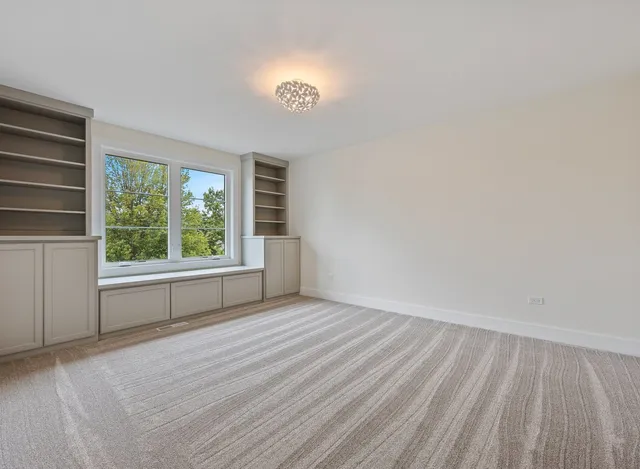 a view of a livingroom with a fireplace a chandelier wooden floor and a fireplace