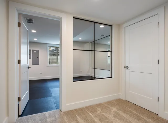 a living room with fireplace furniture and a large window