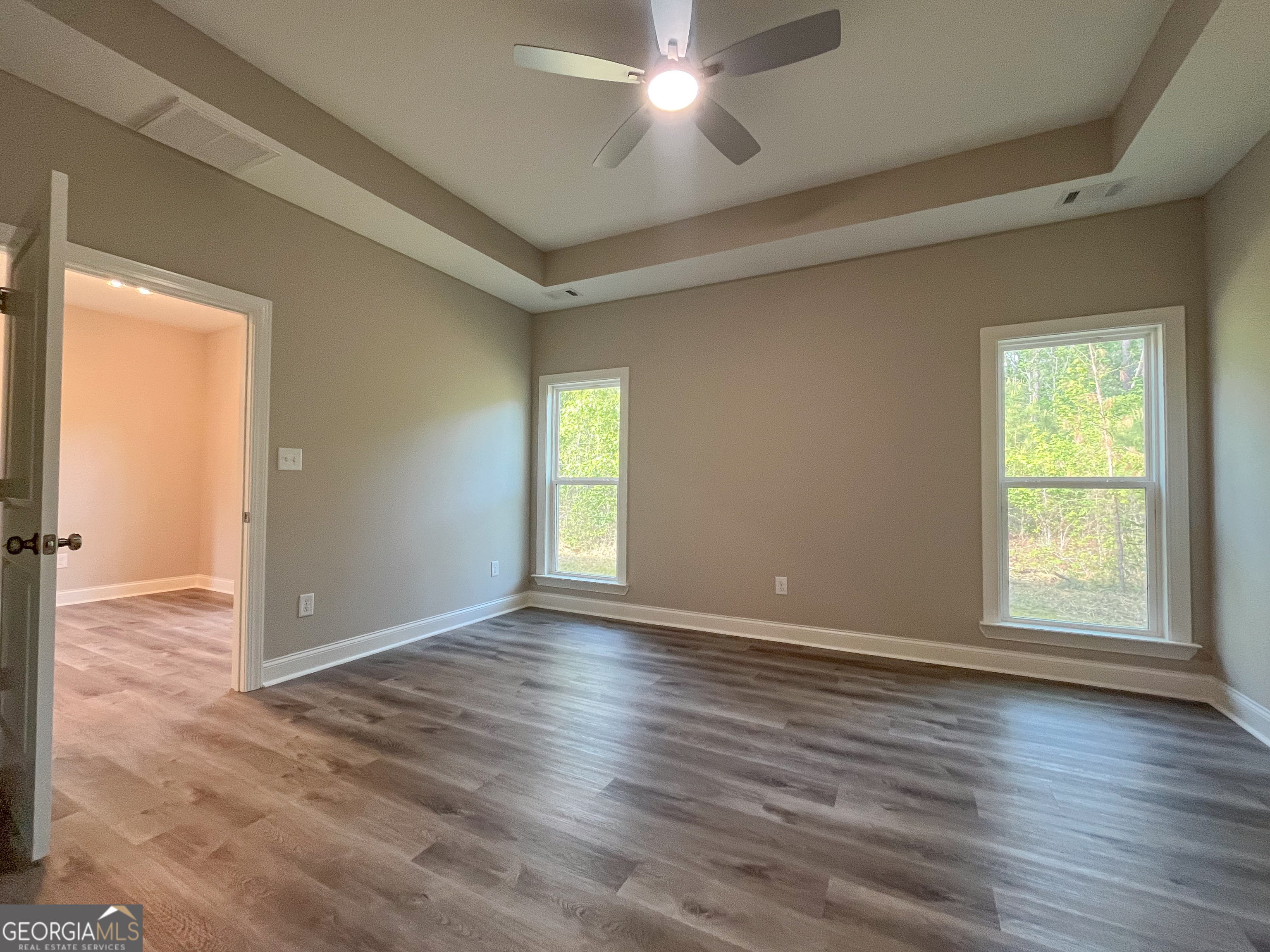711 Flanders Lane Dublin, GA 31021 - Photo 22 of 49 an empty room with wooden floor and windows