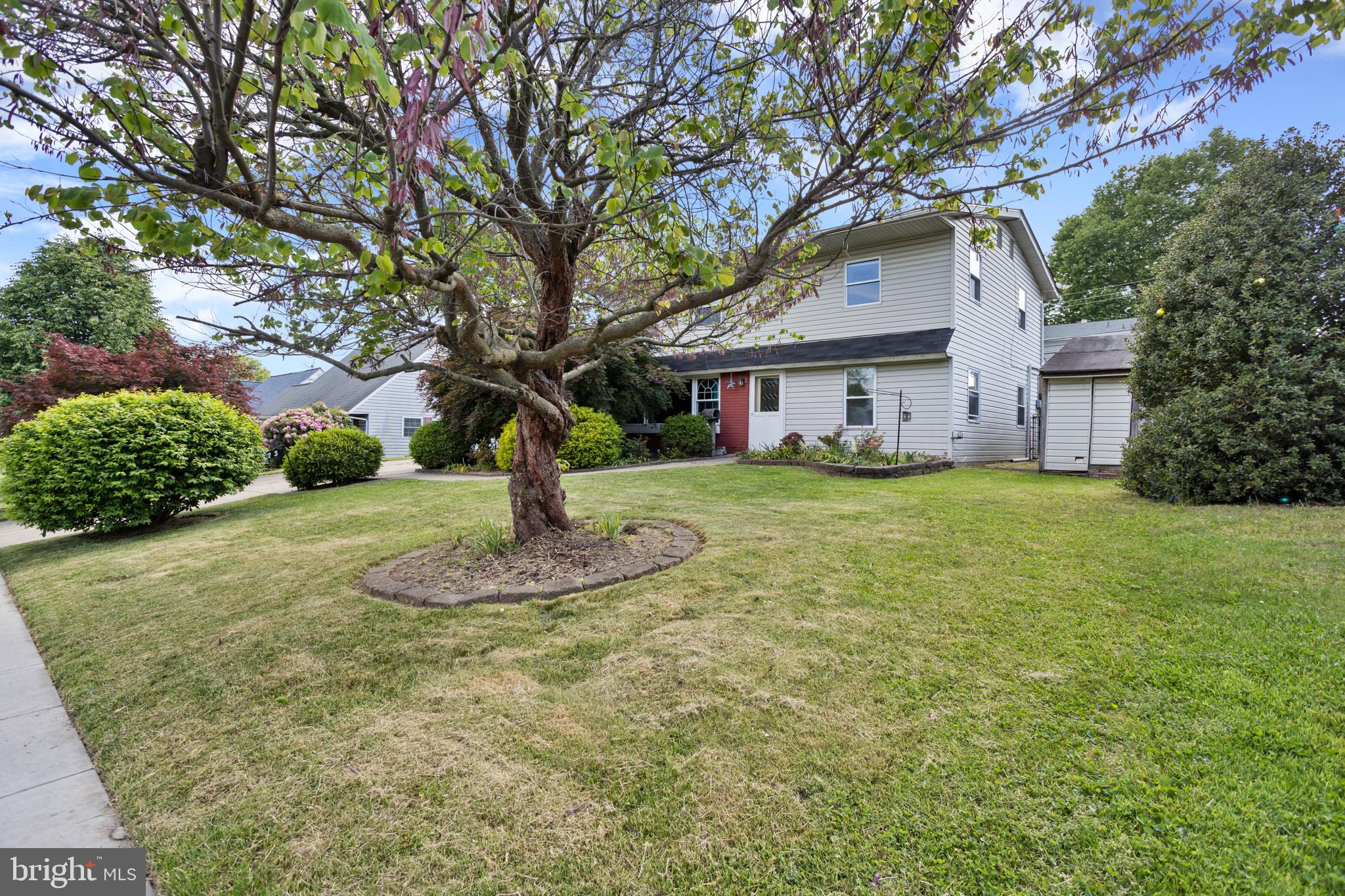 23 Cotton Road Levittown, PA 19057 - Photo 36 of 36 a white house that has a tree in front of it
